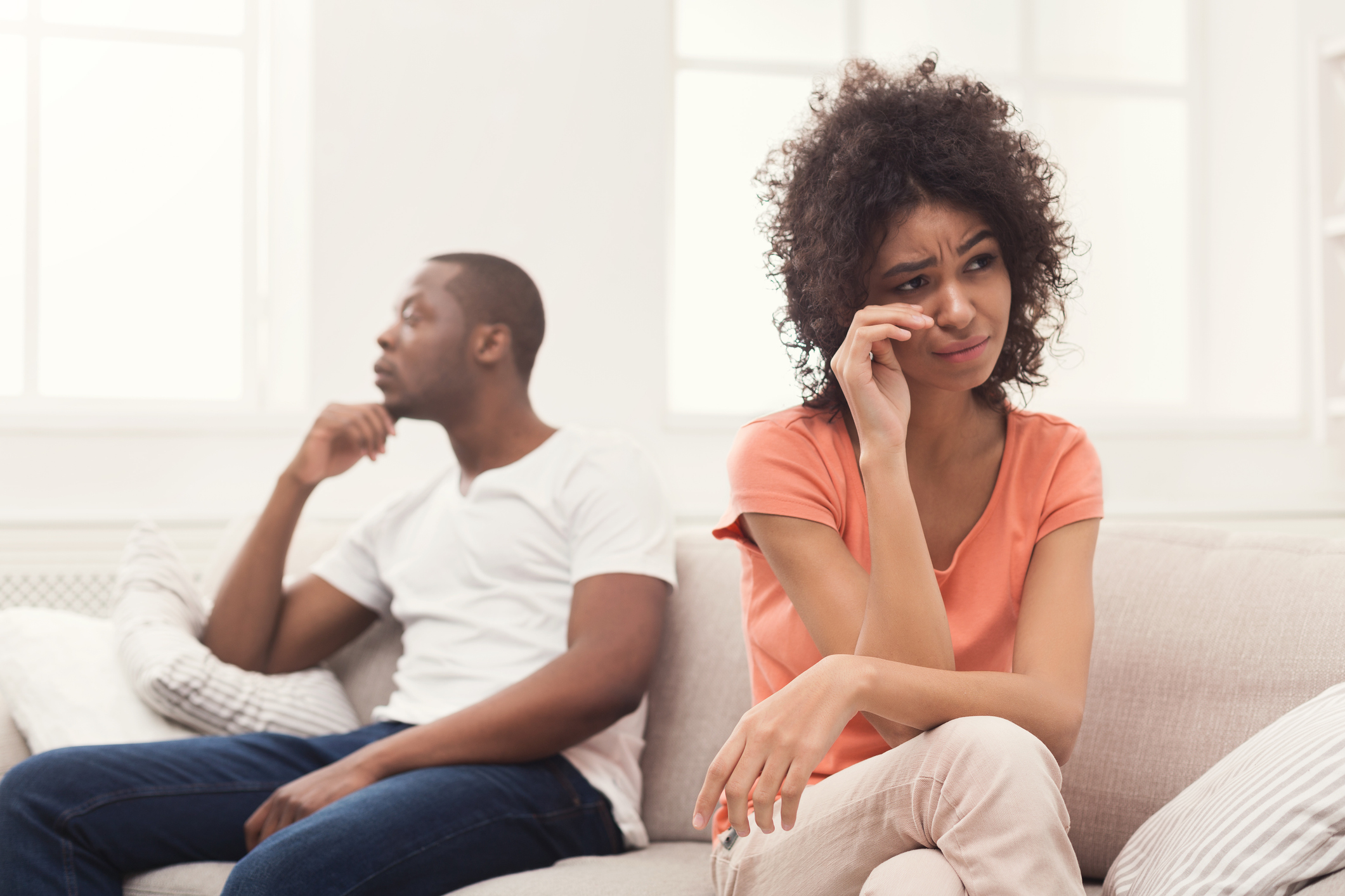 Upset black couple fighting on the couch